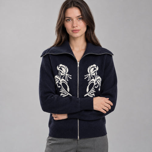 Navy blue zip-front cashmere cardigan worn by a model against a neutral studio backdrop.