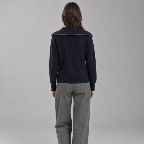 Back of the navy blue zip-front cashmere cardigan worn, showing the centre back seam.