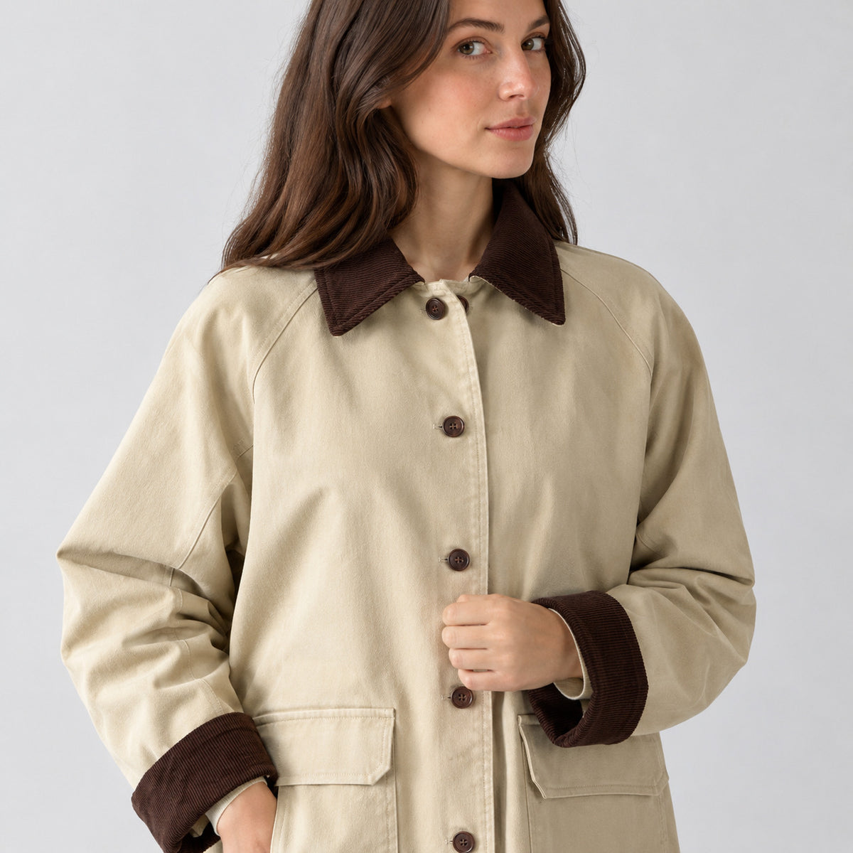 Light beige barn jacket worn, cropped from the shoulders to the waist to show the corduroy collar and button placket.