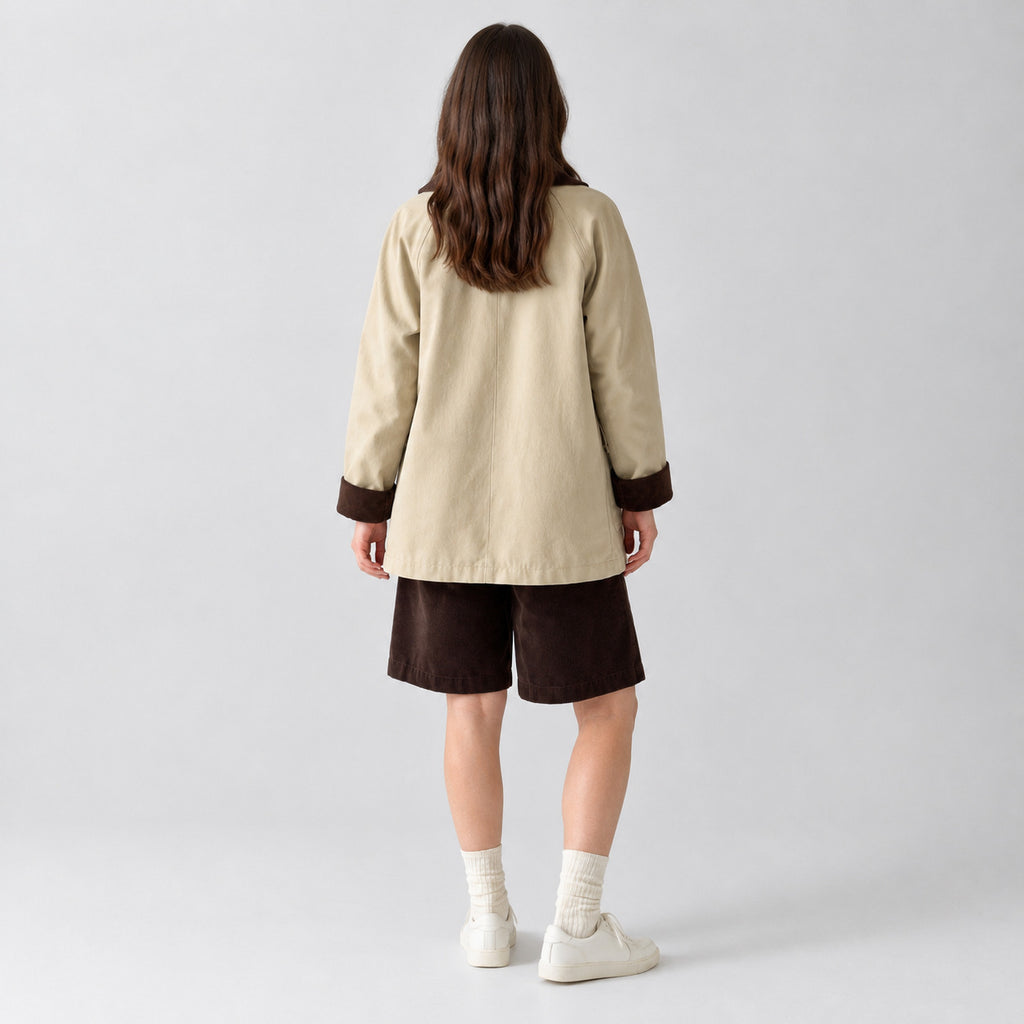Back of the light beige barn jacket worn, showing the raglan sleeve seams.