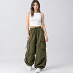 Army green wide-leg parachute cargo pants worn by a model in a neutral studio setting.