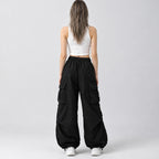 Back of the black wide-leg parachute cargo pants worn, showing the elastic waistband.