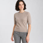 Camel crewneck half-sleeve sweater worn by a model in a neutral studio.