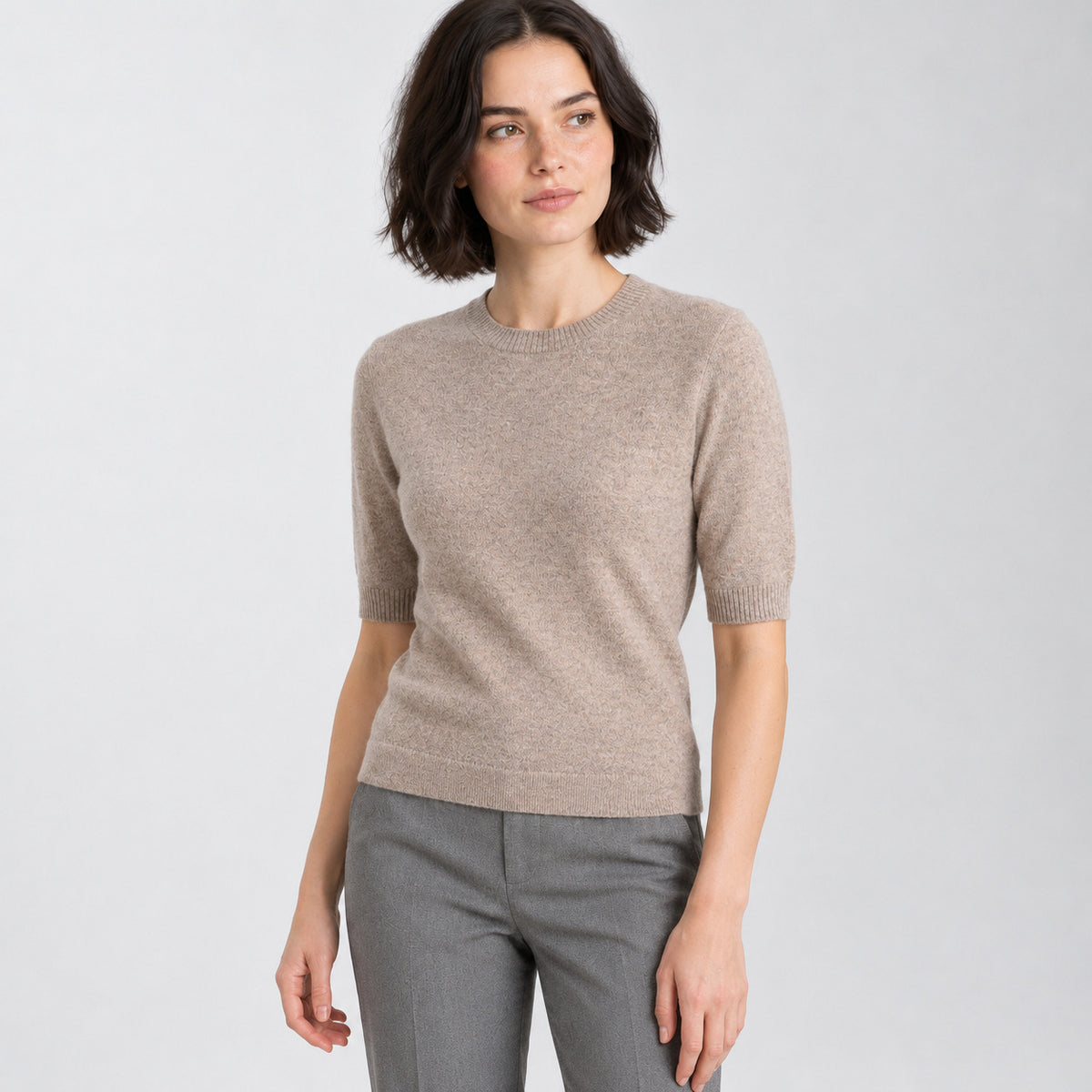 Camel crewneck half-sleeve sweater worn by a model in a neutral studio.