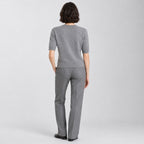 Back of the heather gray crewneck sweater worn, showing the plain knit back.
