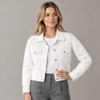 White pearl-embellished denim jacket worn by a model in a neutral studio.