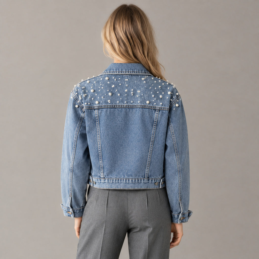 Back of the light blue pearl-embellished denim jacket worn, showing the pearl-studded back yoke.