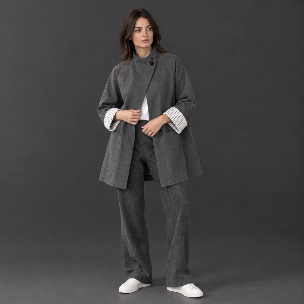 Gray relaxed stand-collar trench coat worn by a model against a neutral studio backdrop.