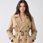 Khaki belted short trench jacket worn, cropped from the shoulders to the waist to show the lapels, storm flap, and belted closure.