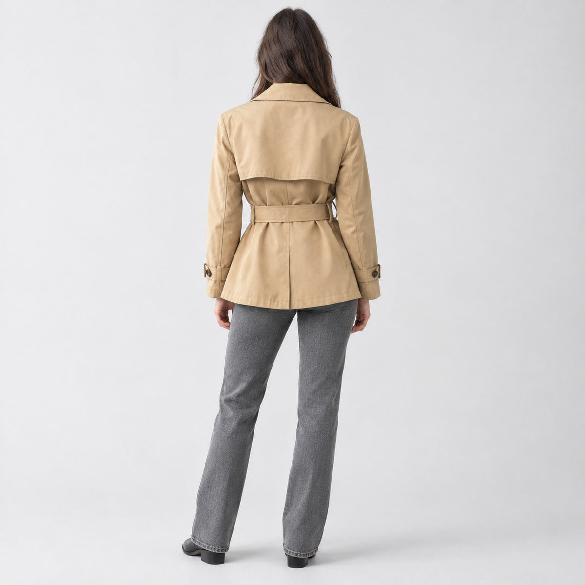 Back of the khaki belted short trench jacket worn, showing the back yoke.